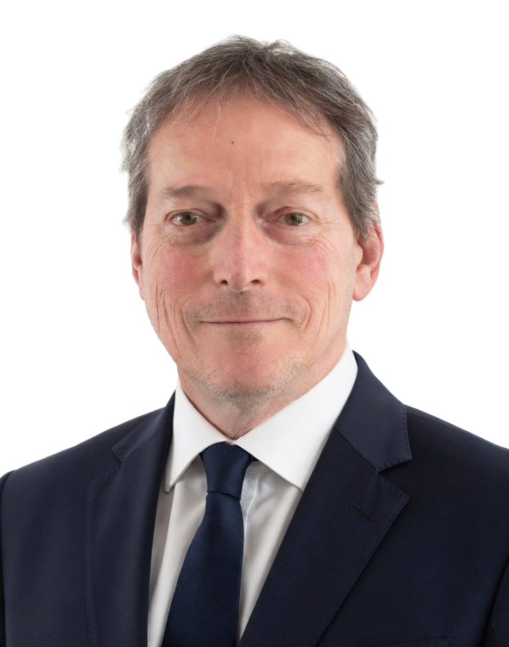 Richard Dufresne in formal suit for professional profile.